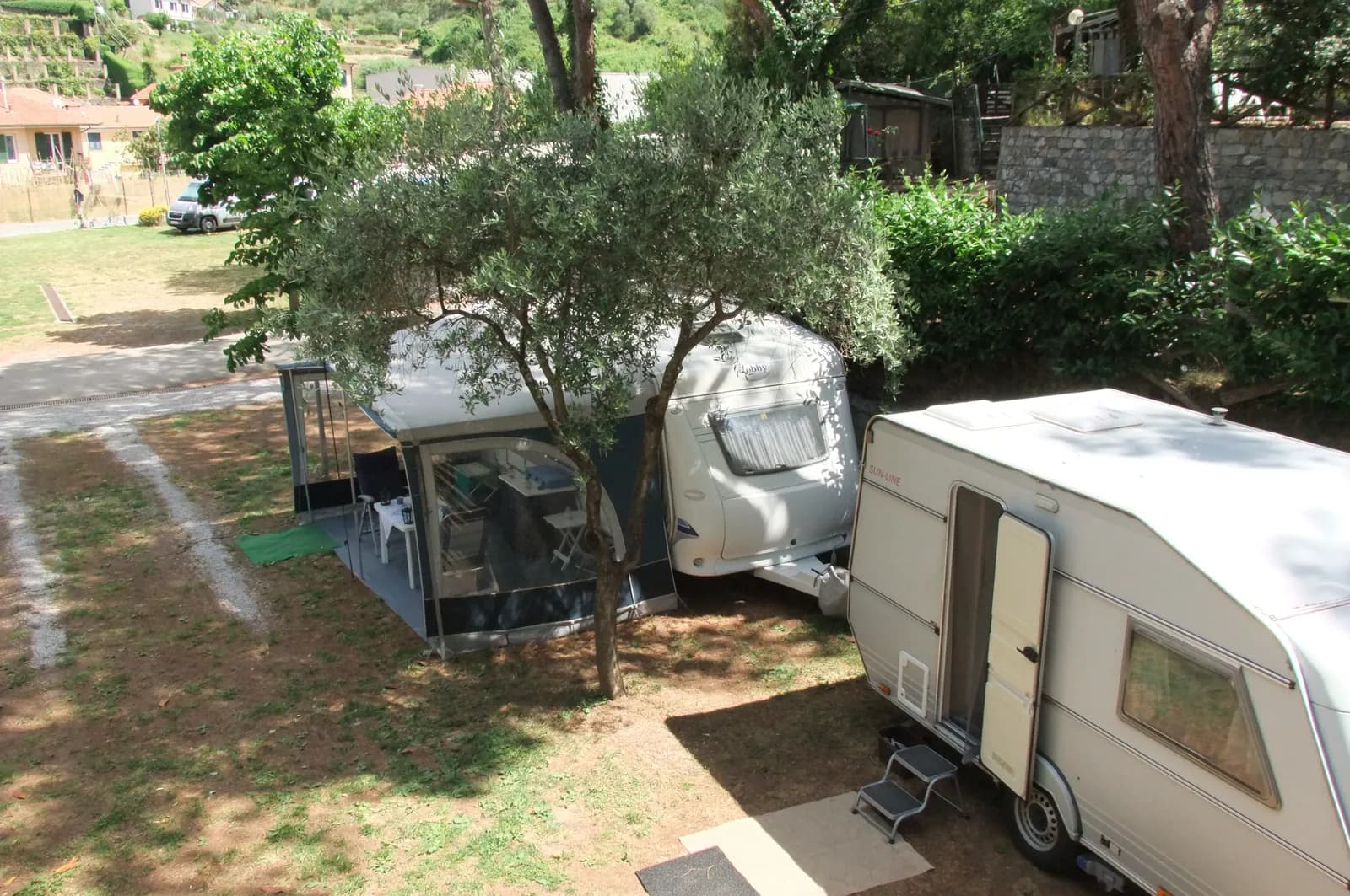 Caravans parked among the campsite trees
